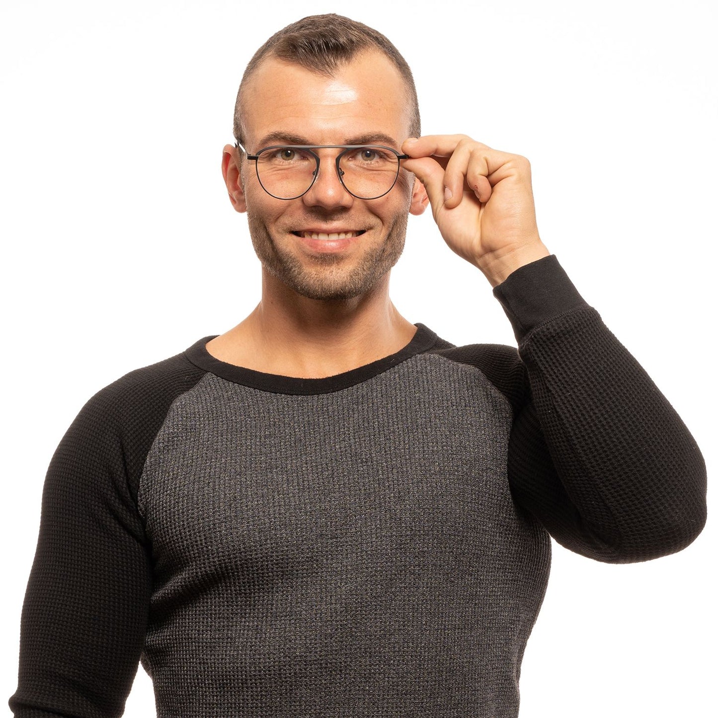 Man wearing Yohji Yamamoto Black Plastic Glasses (Frames) with full-rim round style and black frame, smiling in a grey sweater.