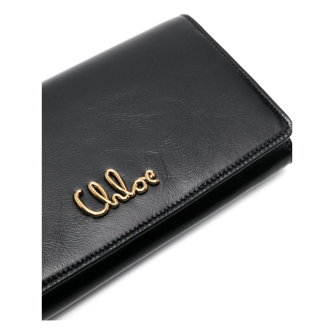 Chloé black leather flap chain crossbody bag with gold logo detail and magnetic fastening.