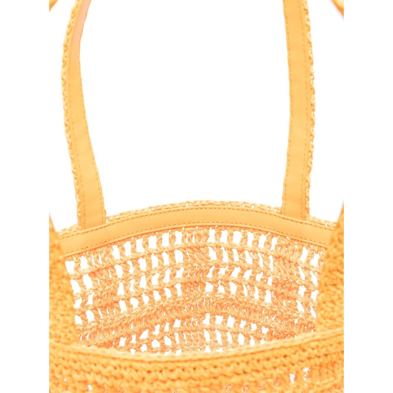 Close-up of carrot orange hand-woven Tory Burch Ella small shopping bag with open top and handles.