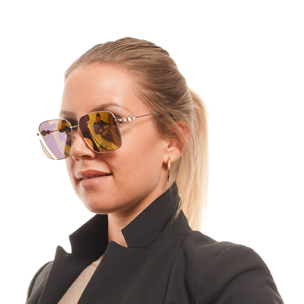Woman wearing Swarovski gold sunglasses with mirrored lenses and metal frame, showcasing full-rim square style for women.