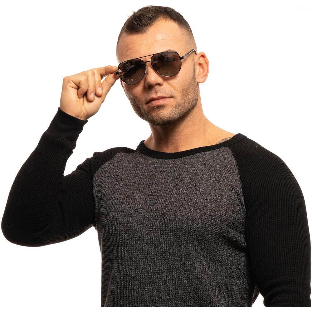 Man wearing Guess gray aviator sunglasses with gunmetal frame and mirrored silver lenses, stylish full-rim design for men.