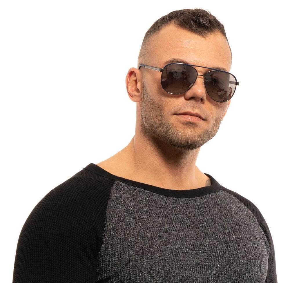 Man wearing GUESS gray aviator sunglasses with gunmetal frame and mirrored lenses