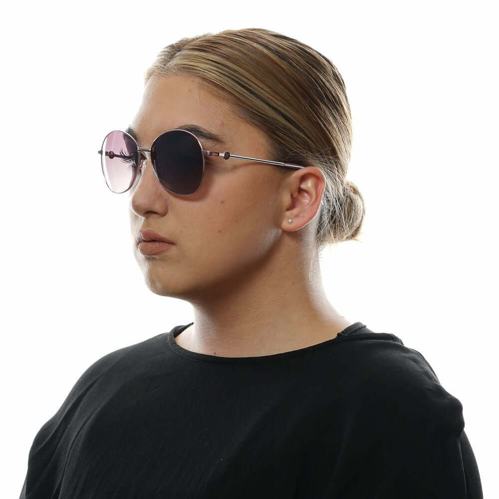 Woman wearing Missoni rose gold aviator sunglasses with purple lenses, featuring metal-plastic frame for 100% UVA & UVB protection.