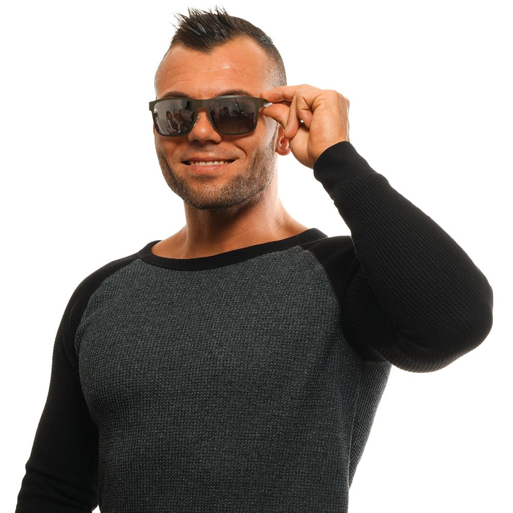Man wearing Guess Gray Men Sunglasses with metal frame and grey lenses.