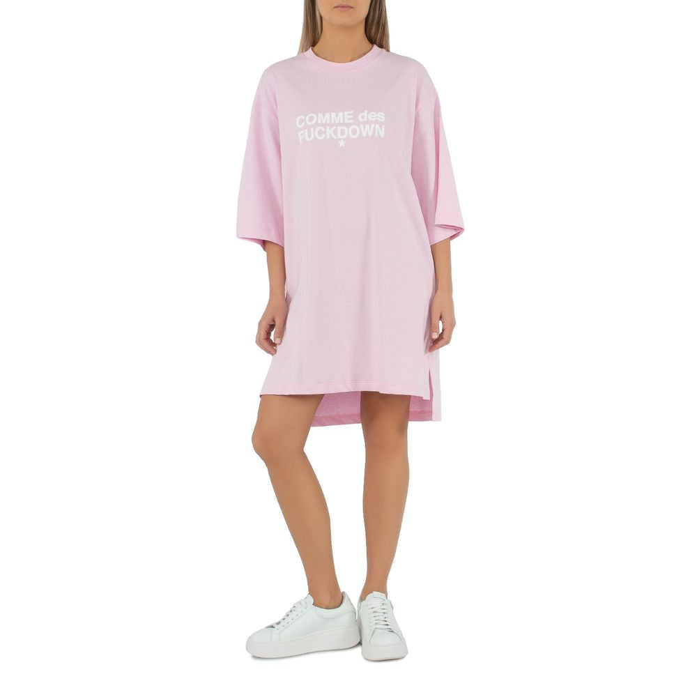 Comme Des Fuckdown pink cotton oversized t-shirt dress with logo print on chest, styled with white sneakers
