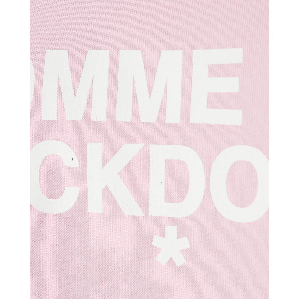 Close-up of Comme Des Fuckdown logo on a pink cotton dress.