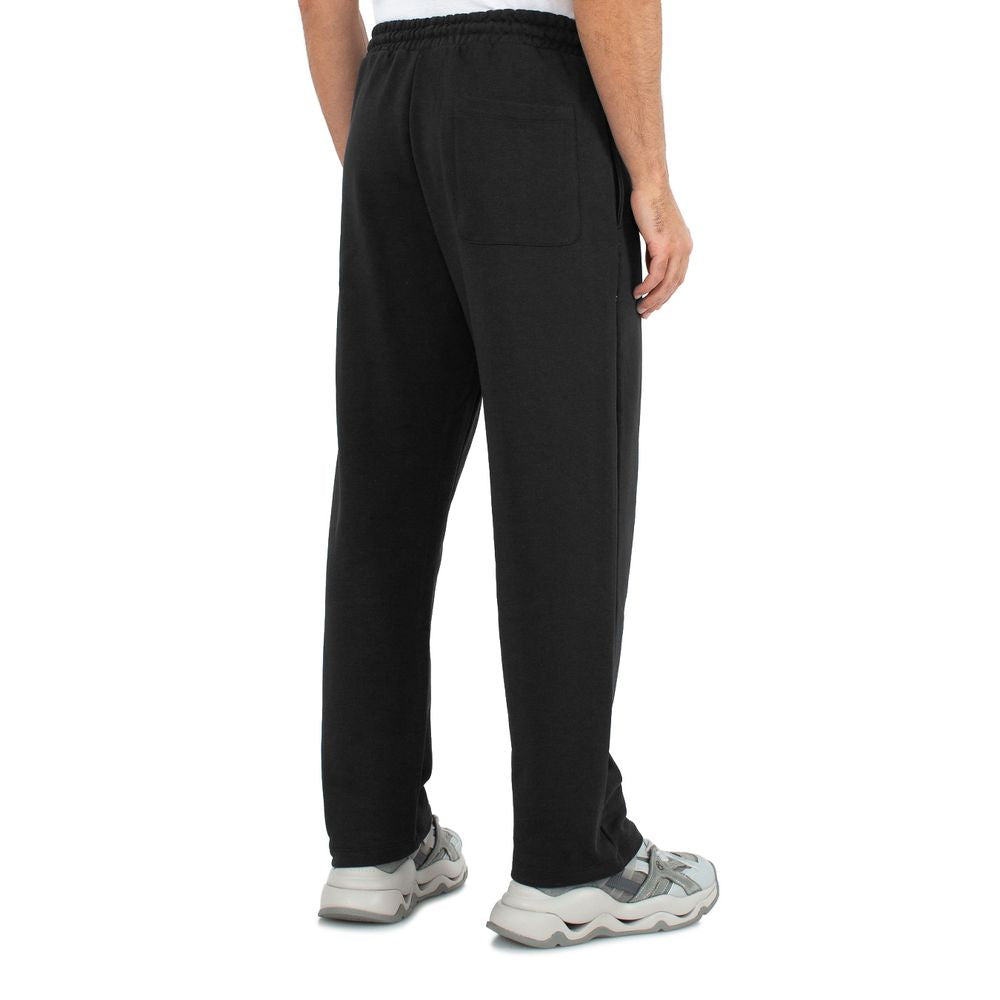 Back view of Comme des Fuckdown black cotton sweatpants with drawstring waist and side pockets
