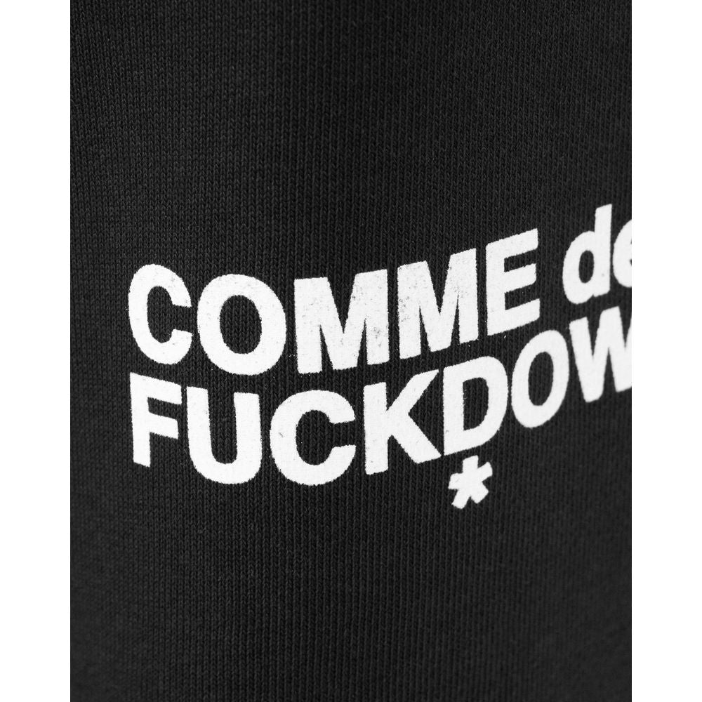 Close-up of Comme des Fuckdown black cotton jeans logo print in white lettering.