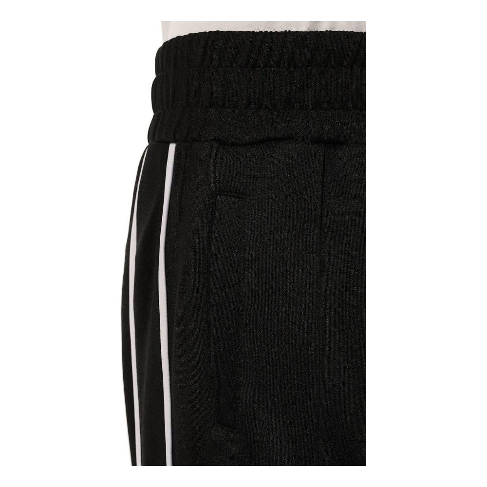 Comme Des Fuckdown black technical fabric pants with white side bands and logo print, featuring two side pockets.