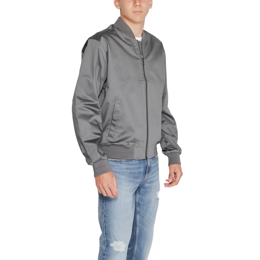 Man wearing Calvin Klein Gray Organic Cotton Bomber, showcasing its modern design and soft fabric.