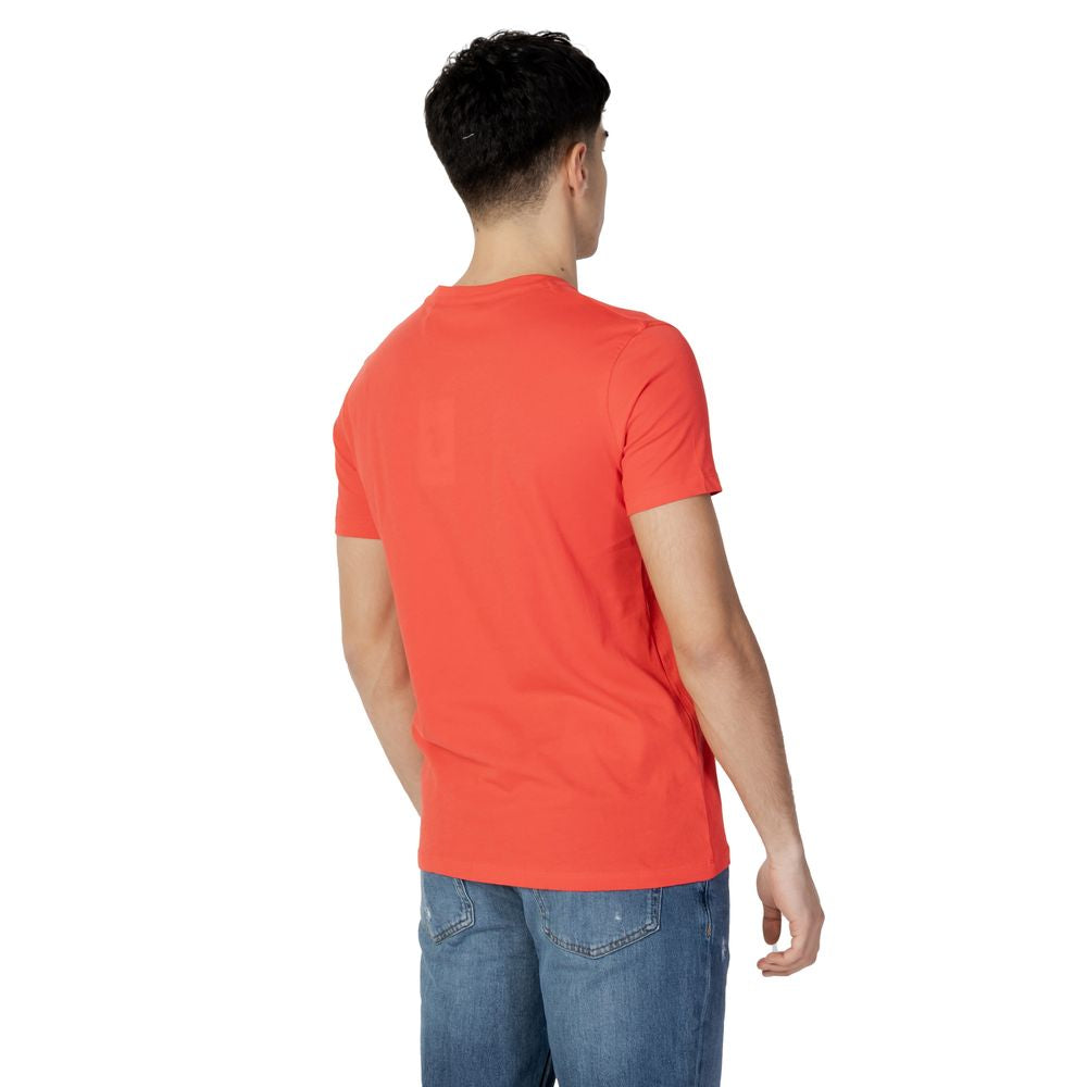 Back view of man wearing U.S. Polo Assn. red cotton t-shirt and jeans, showcasing classic style with short sleeves.