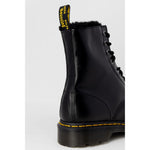 Close-up of Dr. Martens Black Leather Boot showing iconic yellow stitching and durable rubber sole