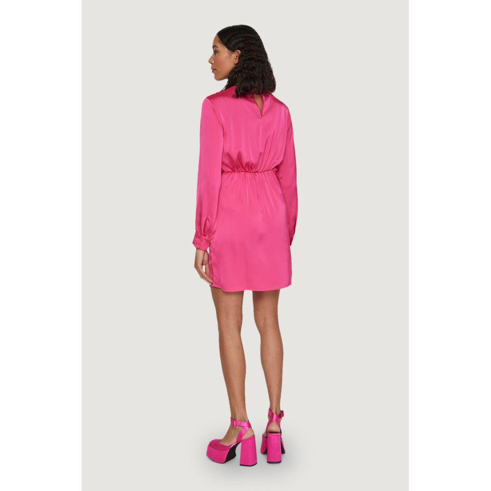 Woman wearing Vila Clothes pink polyester short dress, spring/summer collection, viewed from the back with matching pink platform heels.