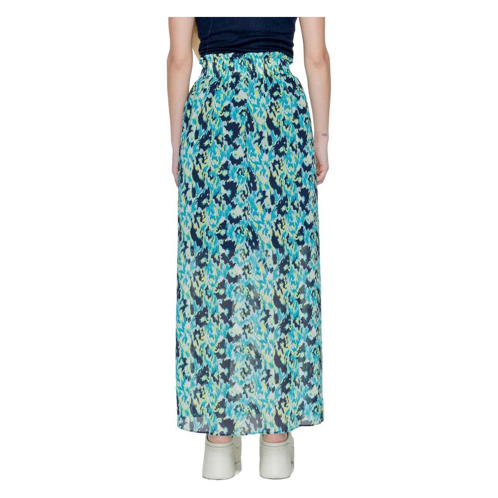 Woman wearing a long Morgan De Toi turquoise polyester skirt, part of the spring/summer collection.