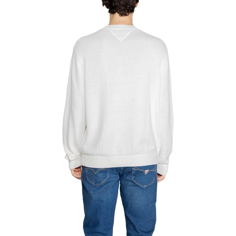 Back view of a man wearing a Tommy Hilfiger white recycled polyester sweater and blue jeans, part of fall/winter collection.