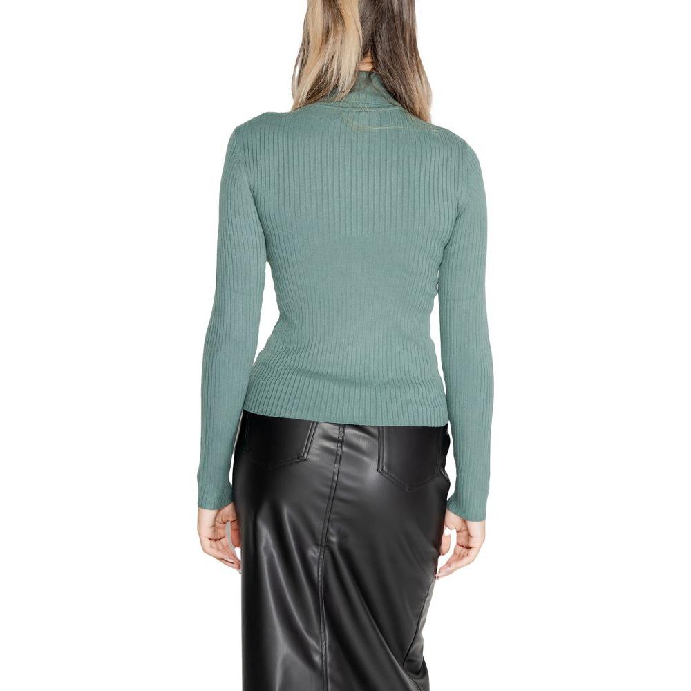 Jacqueline De Yong turquoise viscose women's knitwear, fall/winter collection top, back view, ribbed design, paired with black skirt.