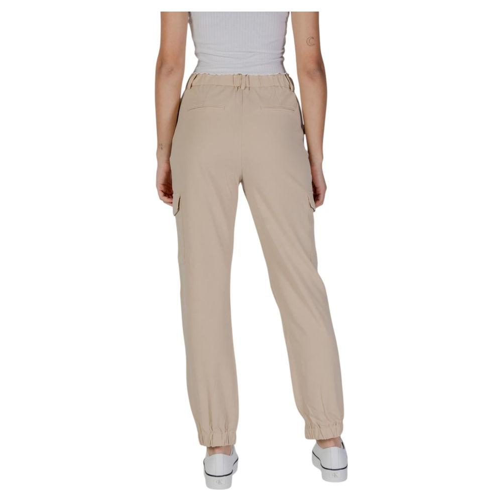 Back view of women's B.Young beige polyester pants from spring/summer collection, featuring relaxed fit and elastic cuffs.