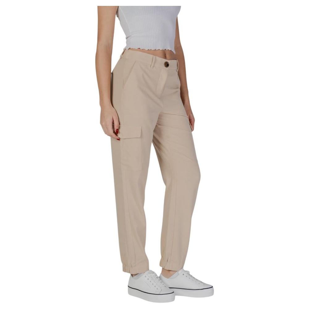 Woman wearing B.Young beige polyester jeans, spring/summer collection, featuring elastic cuffs and pockets. Casual style.