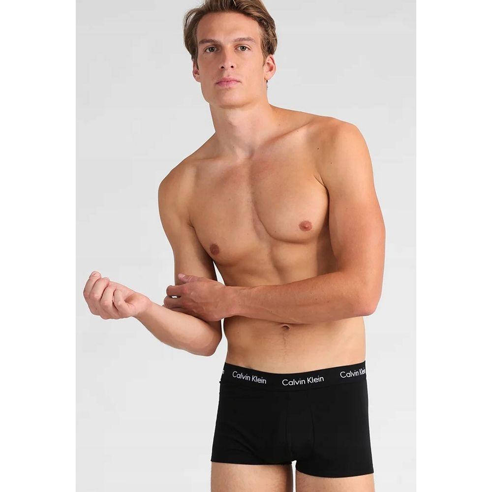 Model wearing Calvin Klein black cotton low-rise trunk boxer, showcasing soft, comfortable fit for everyday wear. Perfect blend of style and comfort.