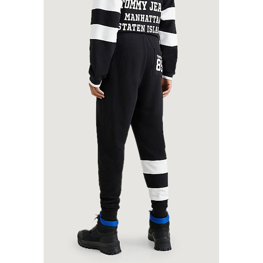Men's black and white cotton pants by Tommy Hilfiger Jeans for Spring/Summer collection, featuring iconic stripe design.