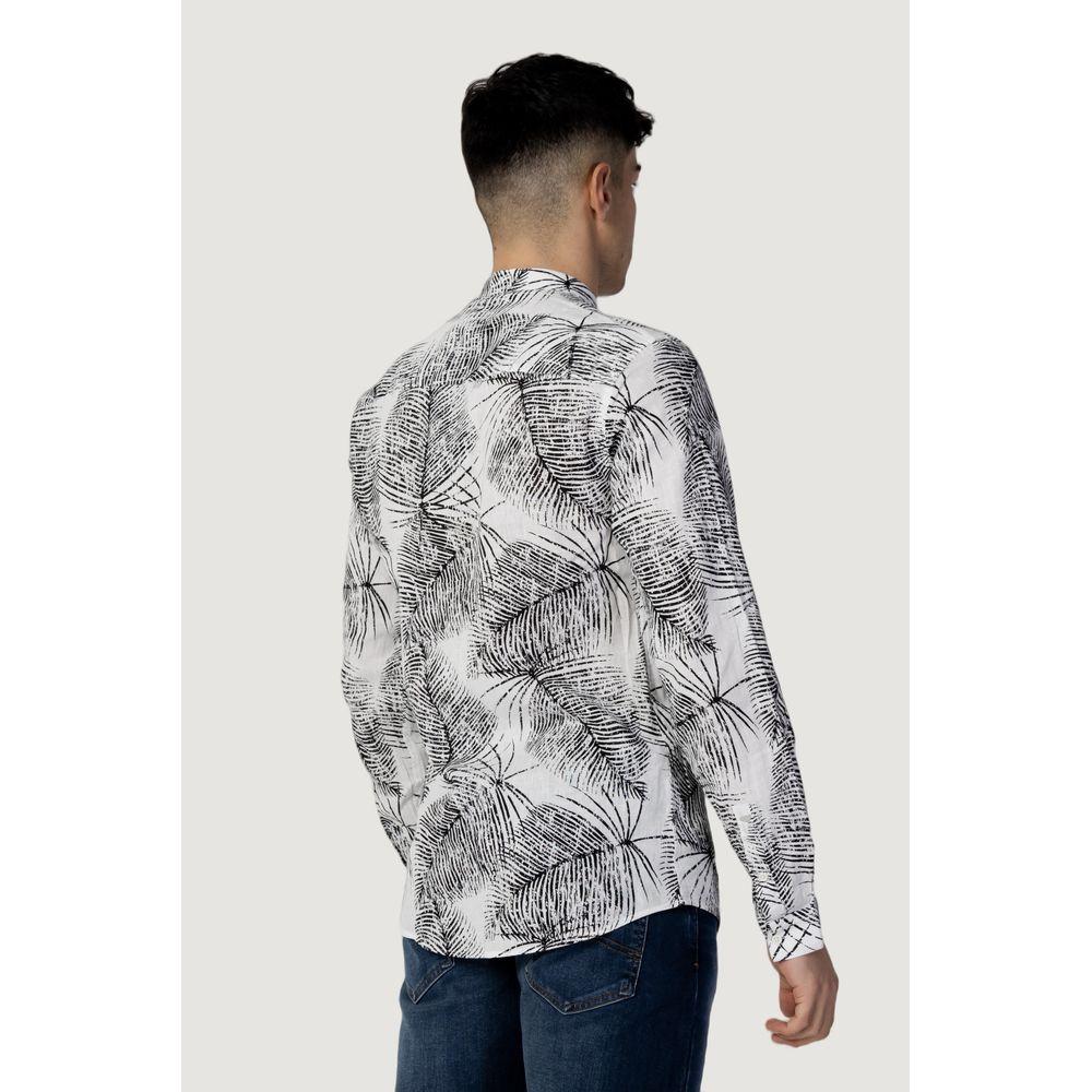 Rear view of a man wearing a patterned long-sleeve shirt with jeans