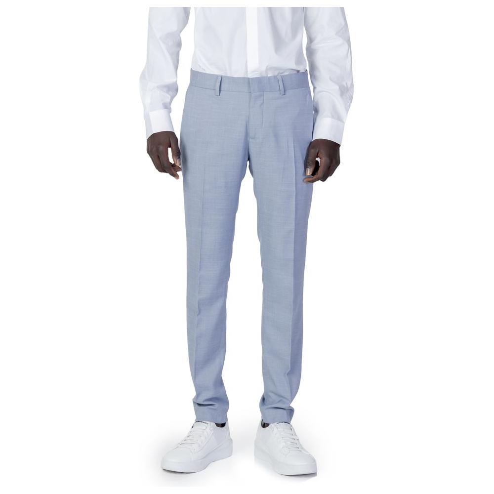 Man wearing Antony Morato blue polyester slim fit pants with white sneakers, ideal for formal occasions.