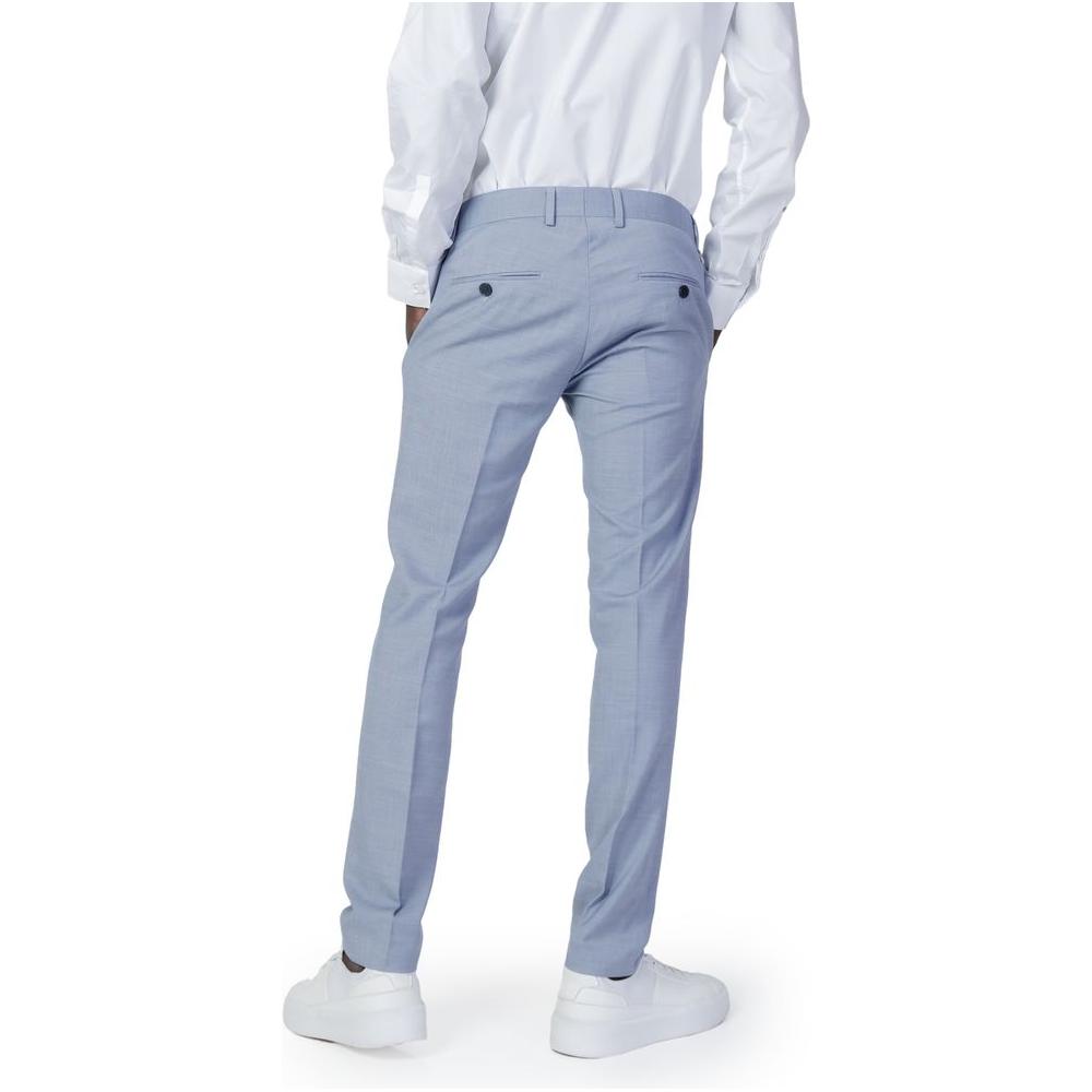 Man wearing Antony Morato blue polyester slim fit pants, showcasing the back view detail and tailored fit.