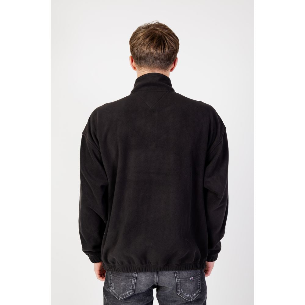 Back view of man wearing Tommy Hilfiger Black Recycled Polyester Sweater, Fall/Winter, 62% recycled polyester, hoodless.