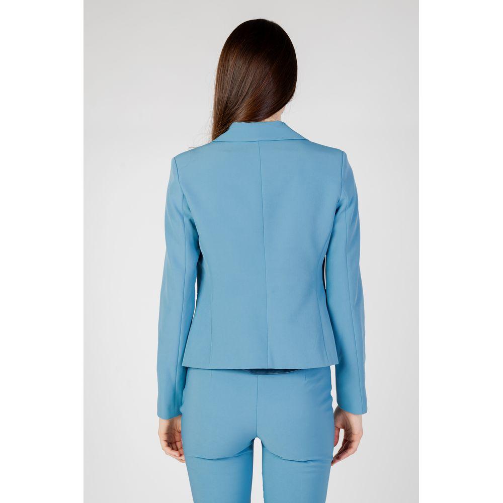 Back view of woman wearing Rinascimento turquoise polyester suit and blazer from autumn/winter collection.