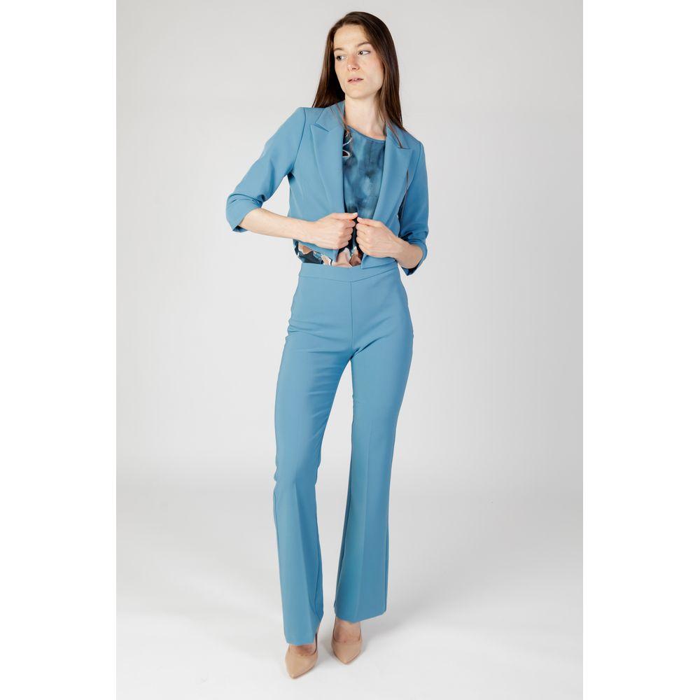 Woman wearing Rinascimento turquoise polyester suit and blazer, autumn winter collection, women's fashion.