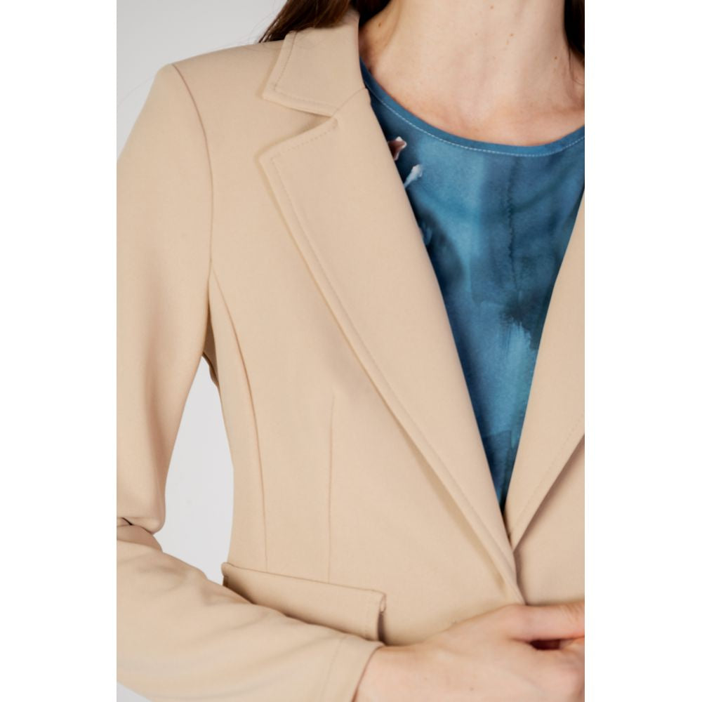Woman wearing Rinascimento beige polyester blazer from autumn/winter collection, showcasing elegant women's fashion.
