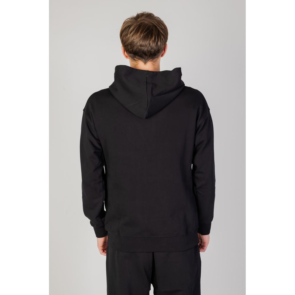 Back view of a man wearing a black cotton hooded sweatshirt from Underclub's Autumn/Winter collection.