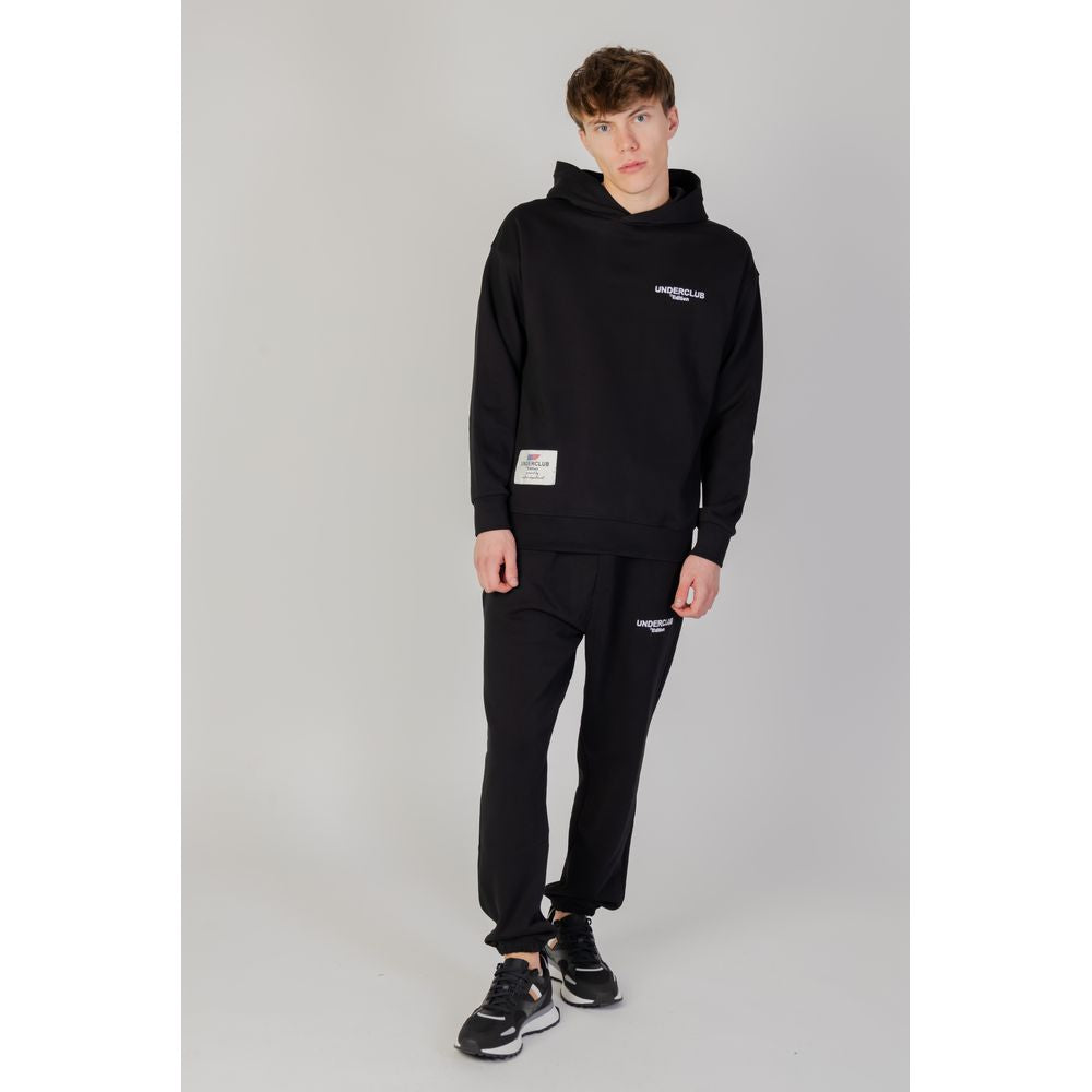 Man wearing Underclub black cotton hooded sweatshirt from autumn/winter collection, 100% cotton, casual attire.