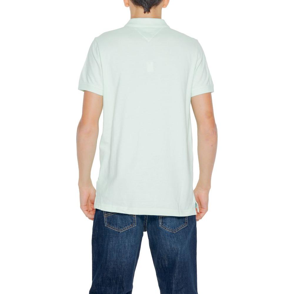 Back view of a man wearing a Tommy Hilfiger green cotton polo shirt and blue jeans, perfect for spring/summer fashion.