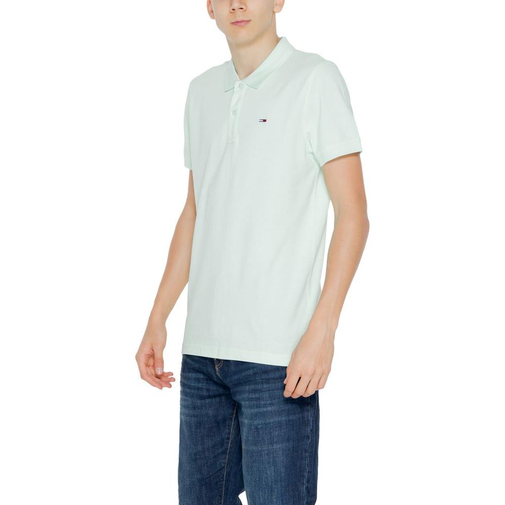 Men's green cotton polo shirt by Tommy Hilfiger, short sleeve, perfect for spring/summer collection, worn with jeans.