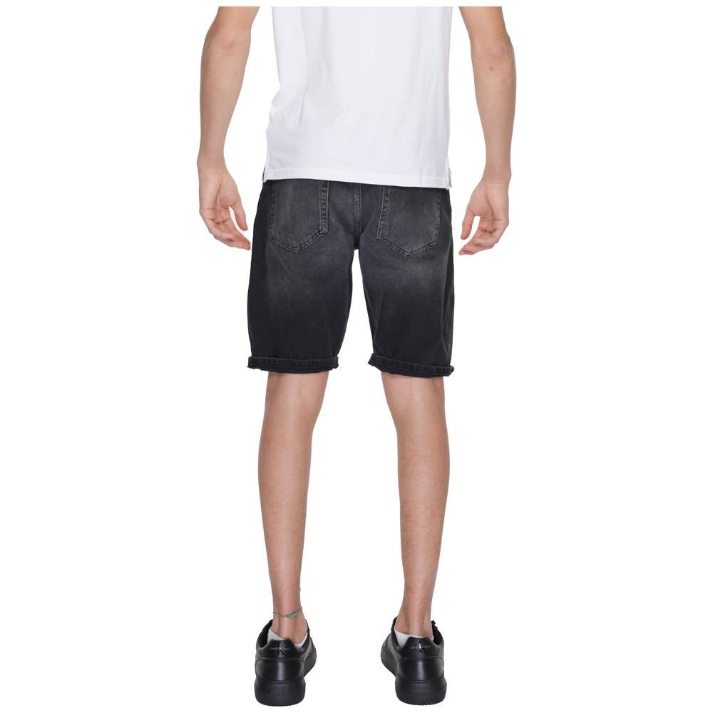 Back view of a man wearing Antony Morato black cotton Bermuda shorts, part of the men's spring/summer collection.