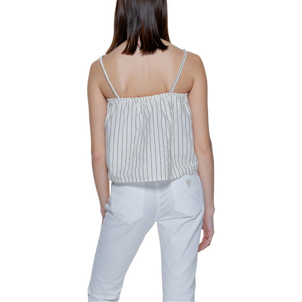 Back view of a woman wearing Vero Moda beige organic cotton tank top for spring/summer fashion