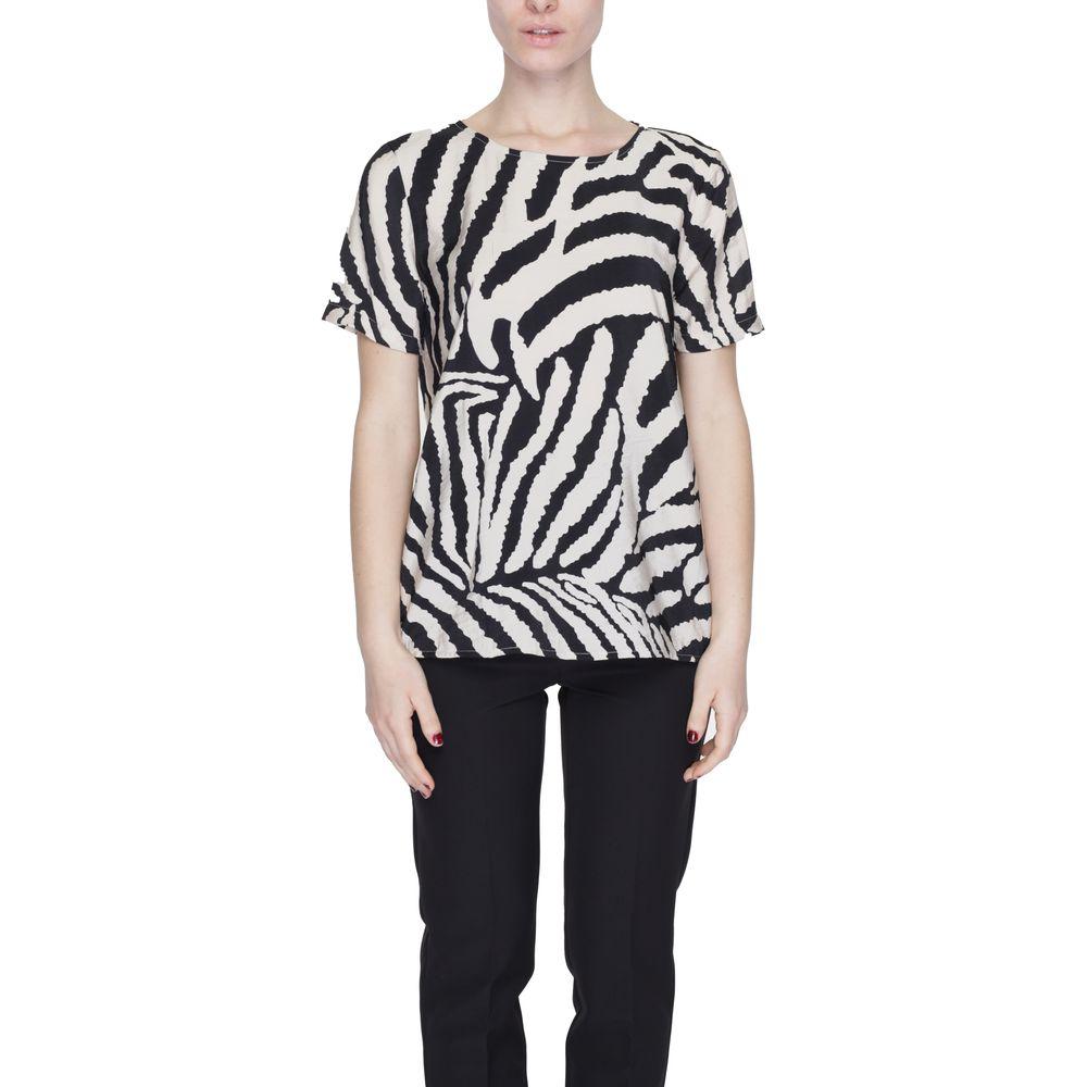 Woman wearing a zebra print short-sleeve top and black pants, showcasing a bold and stylish look