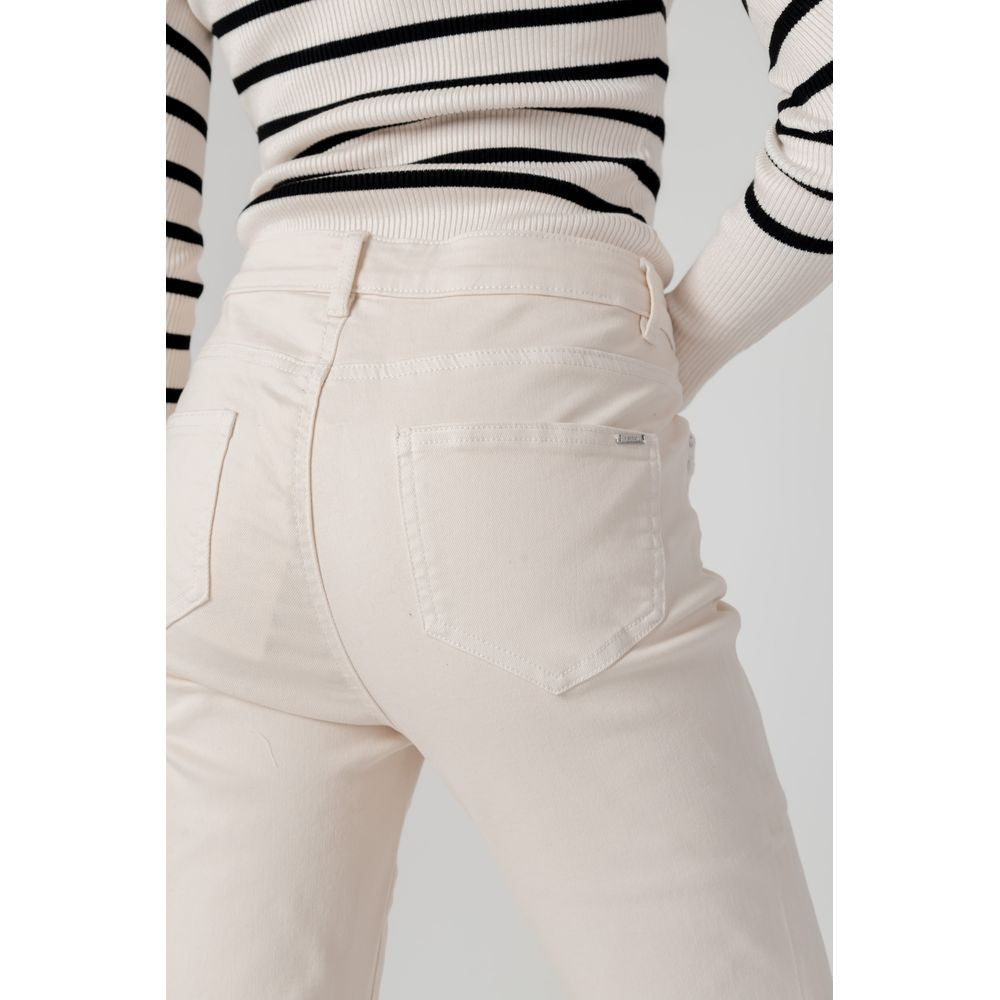 Woman wearing Morgan De Toi beige cotton cigarette pants from fall/winter collection, close-up of pants and striped top.