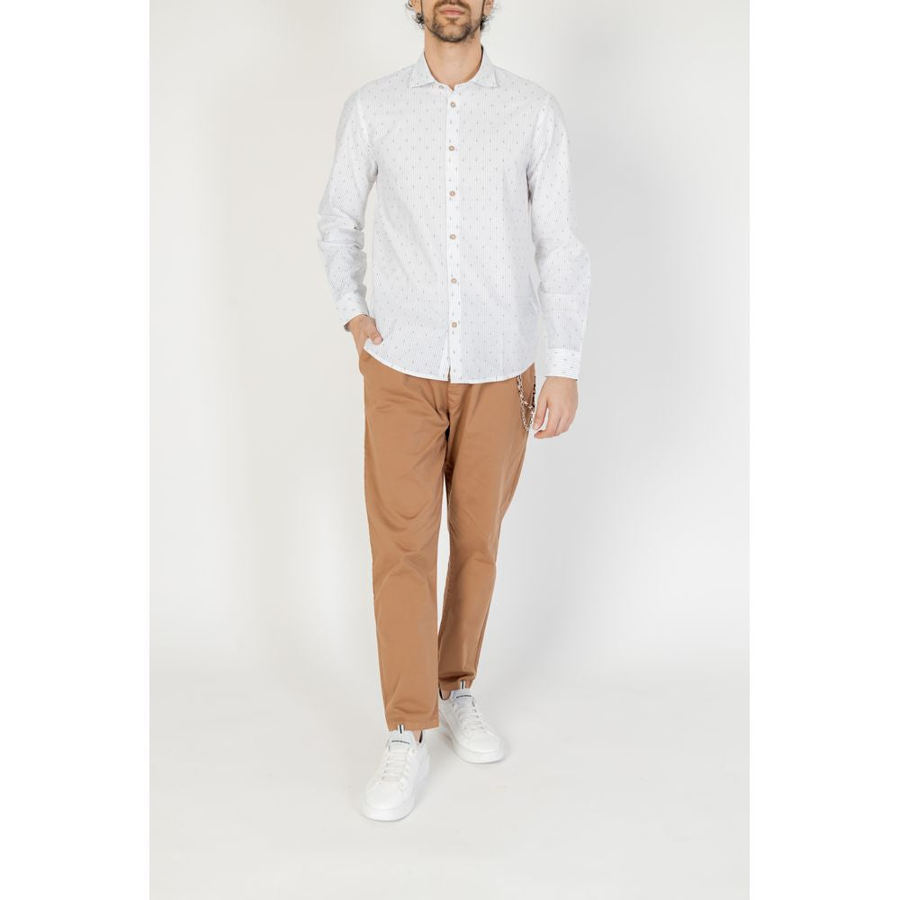 Men's Hamaki-Ho white cotton long sleeve shirt for spring/summer collection, paired with tan pants and white sneakers.