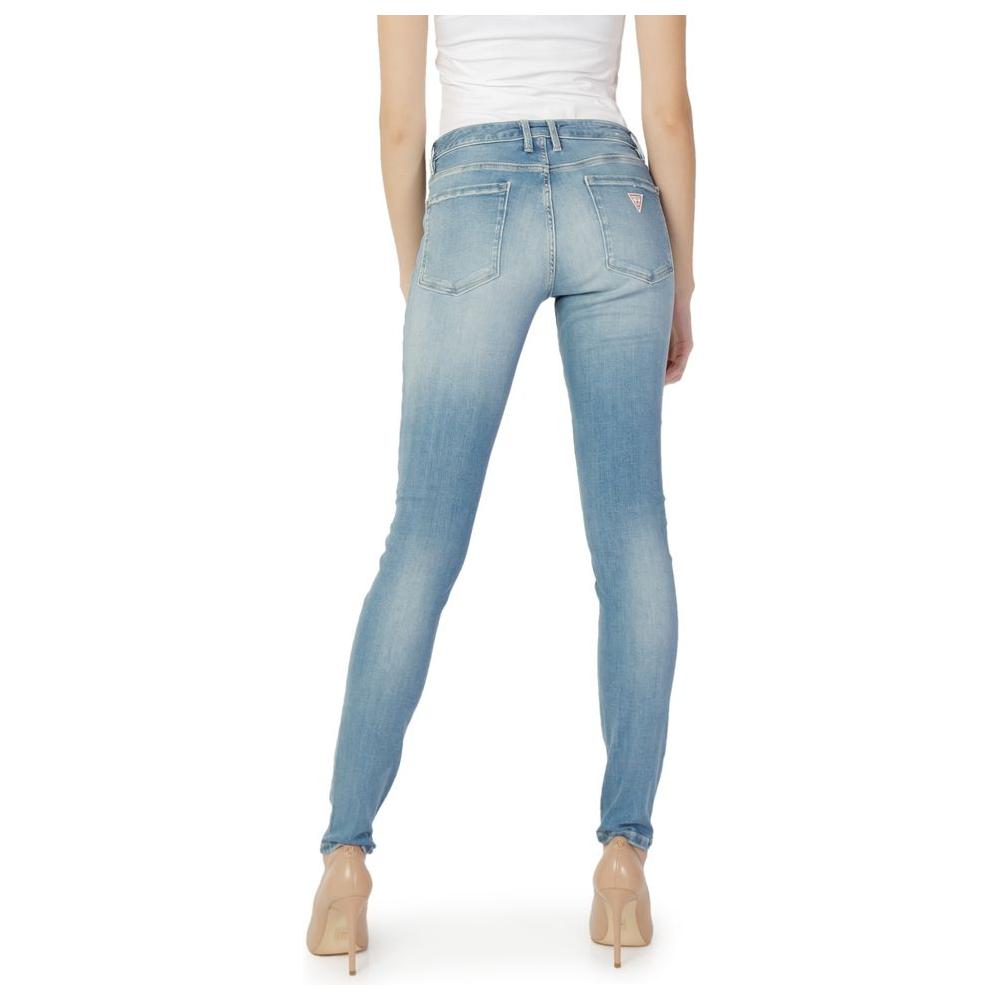 Woman wearing Guess blue cotton skinny jeans, back view showcasing fitted design and high-quality material.