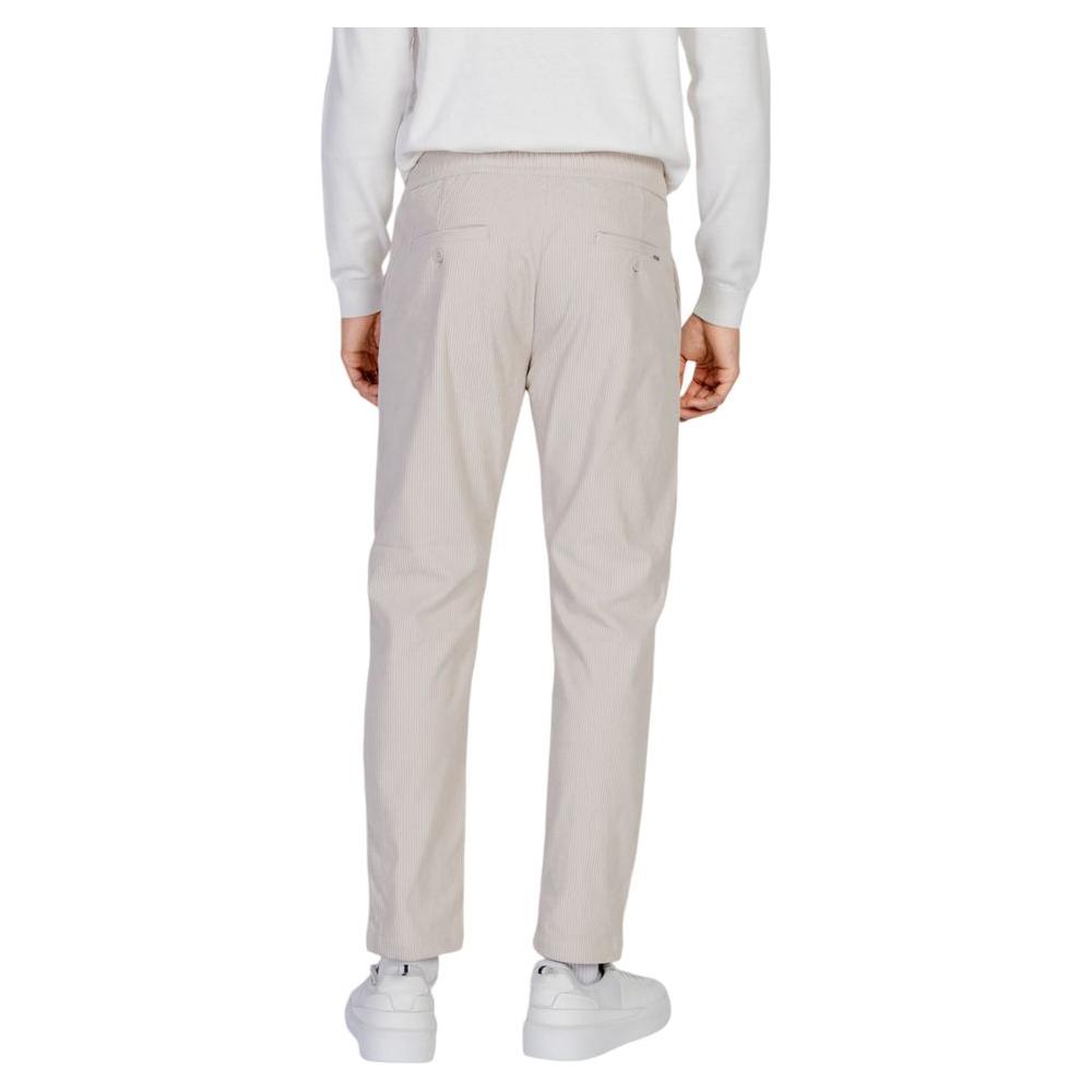 Antony Morato beige men's pants for Fall/Winter collection, made of 100% polyester, shown from back view with white sneakers.