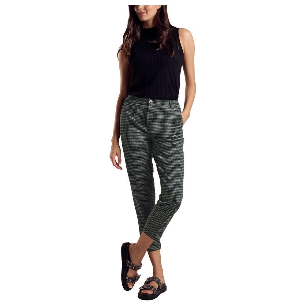 Woman wearing Street One green polyester pants, fall/winter collection, showcasing stylish women's fashion.