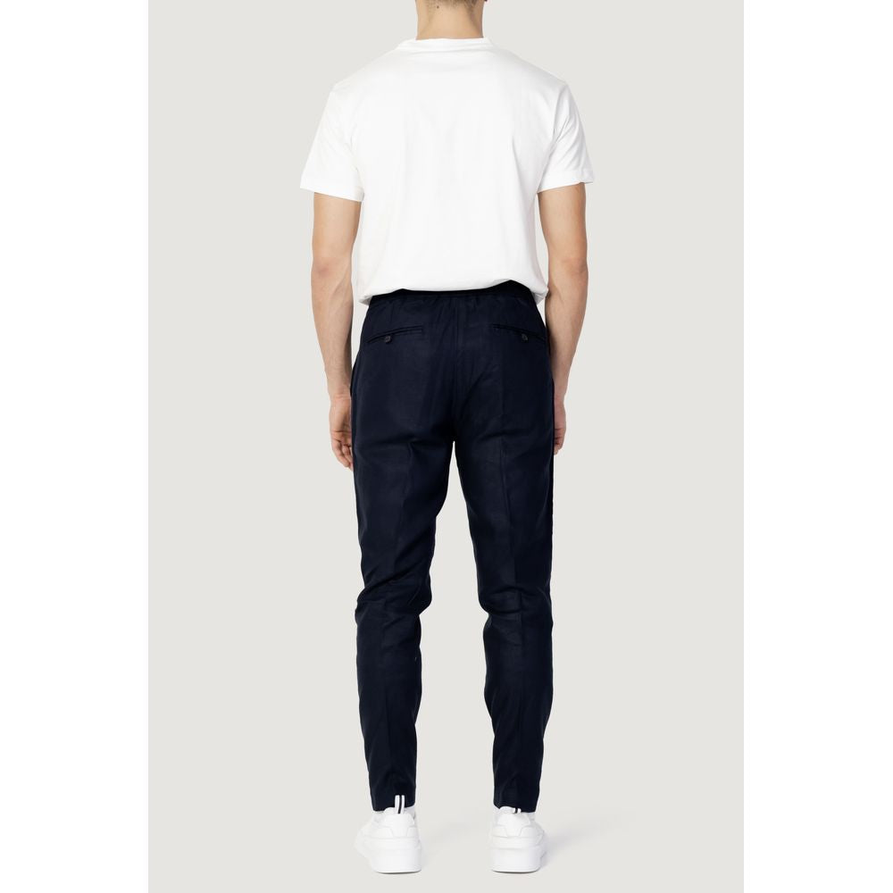 Back view of a man wearing Antony Morato blue linen trousers paired with a white t-shirt, showcasing casual style and comfort.