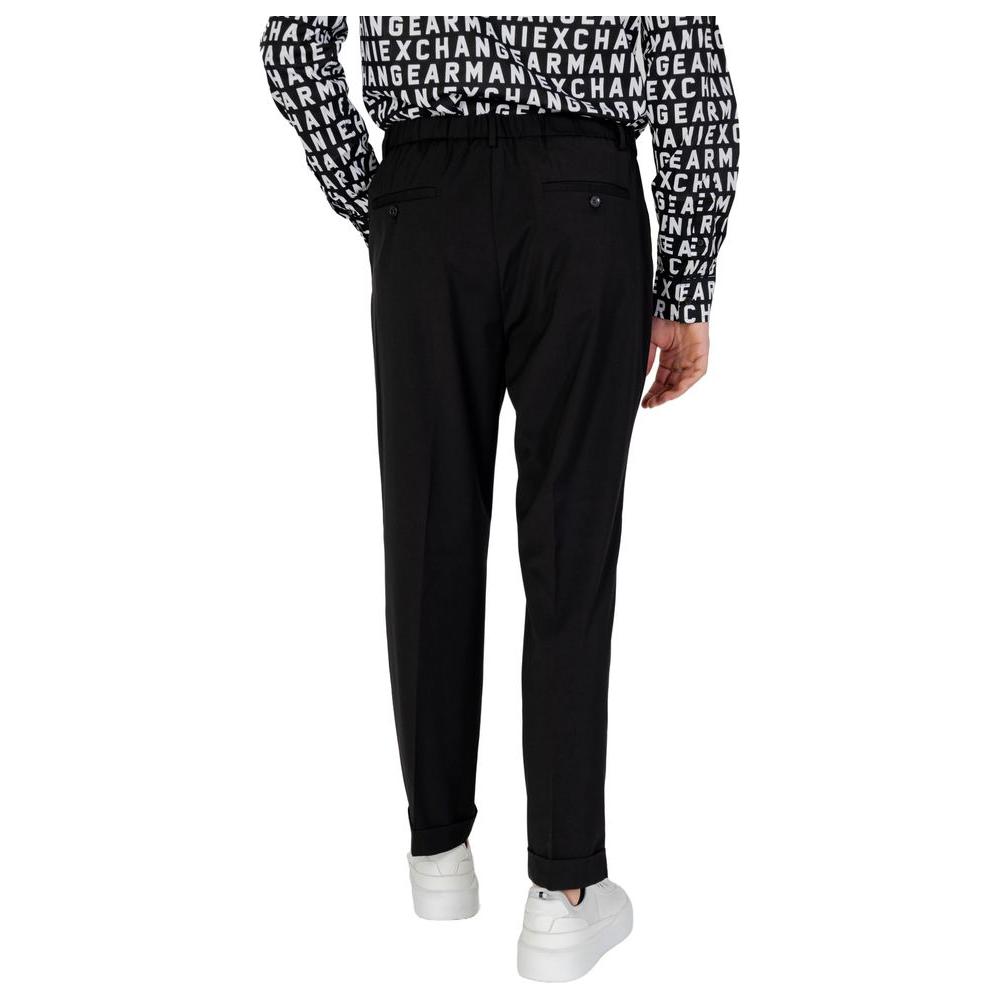 Model wearing Antony Morato black polyester jeans and pants, spring/summer collection, back view, casual style with white sneakers.