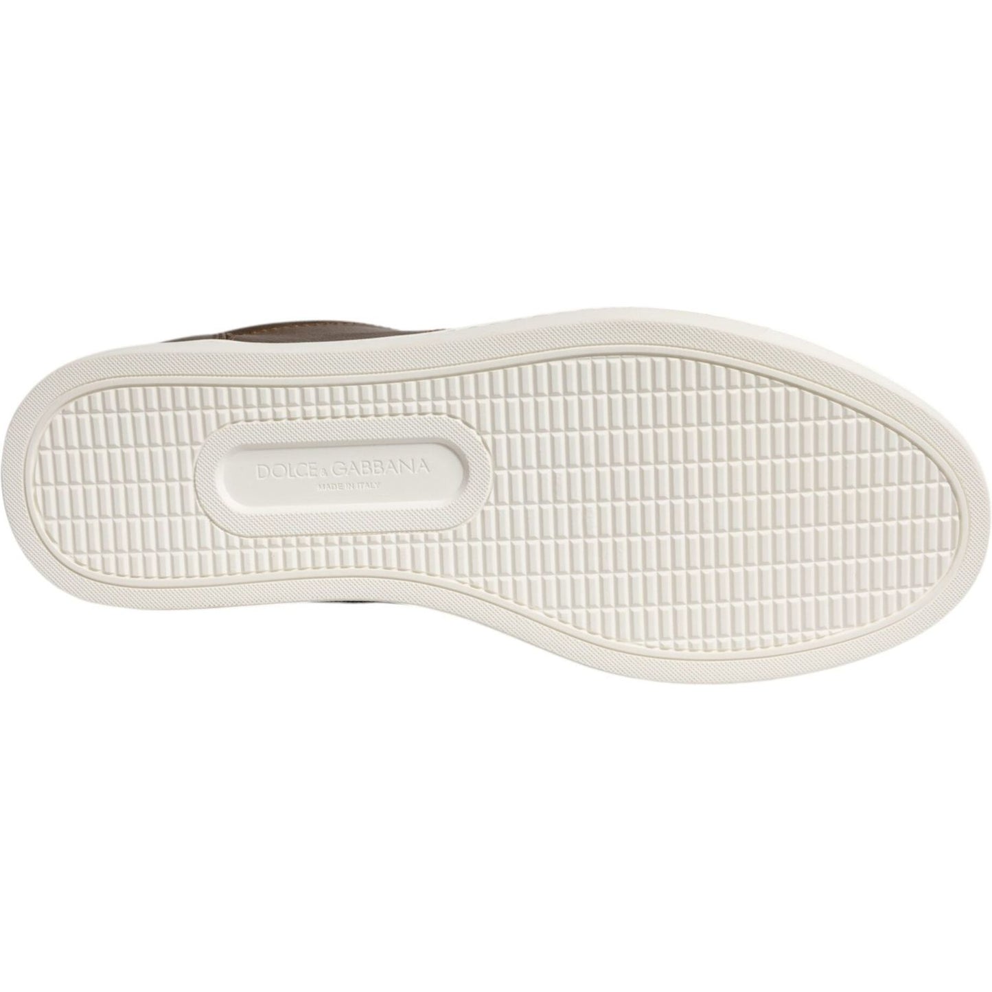 Dolce & Gabbana sneaker sole with brand logo, showing white rubber traction pattern and craftsmanship details.