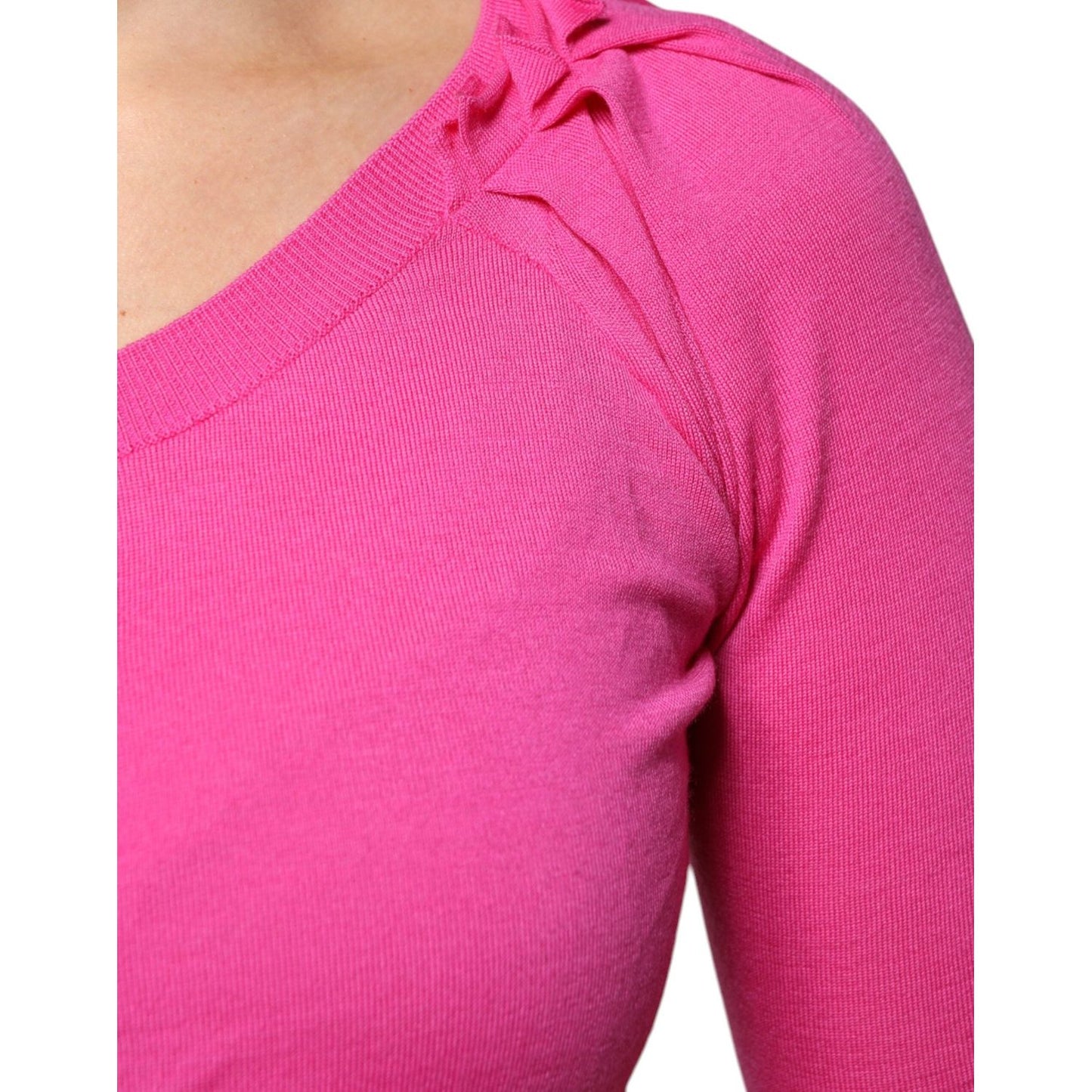 Close-up of pink Dolce & Gabbana wool cardigan sweater showcasing fine knit details and craftsmanship.