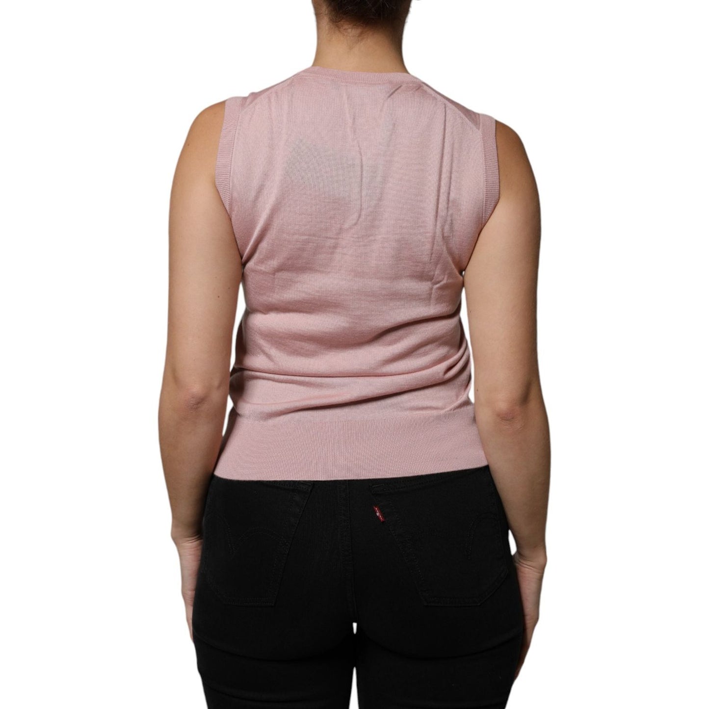 Back view of a Dolce & Gabbana pink cashmere sleeveless tank top, showcasing logo details and high craftsmanship. Made in Italy.