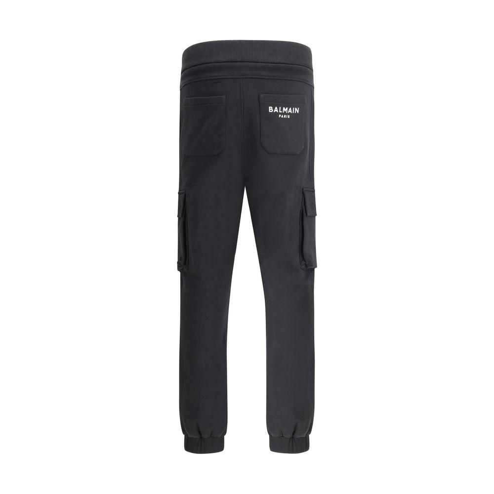 Balmain cotton sweatpants with cargo pockets, elasticated waistband, and monochrome pattern, featuring iconic brand monogram on back.