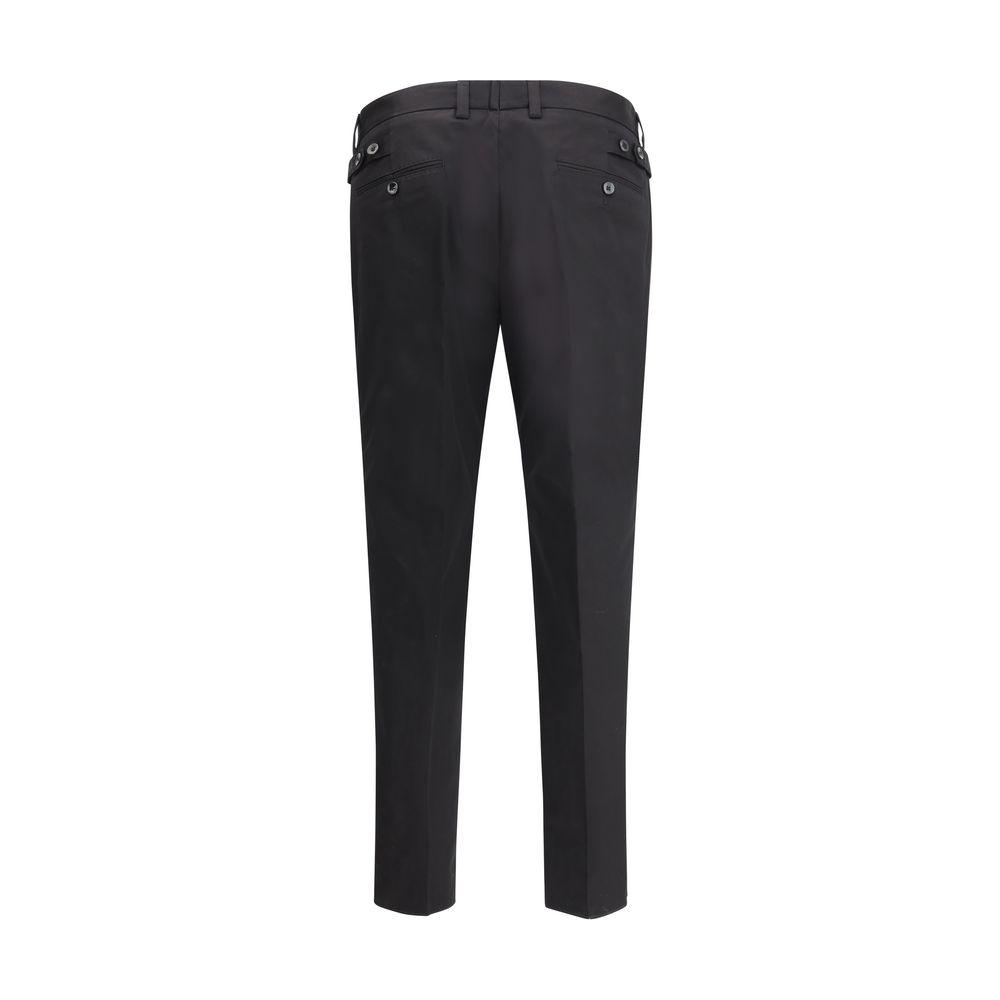 Back view of black Dolce & Gabbana cotton pants, mid-rise with button and zipper, two back welt pockets, waistband loops, regular fit.
